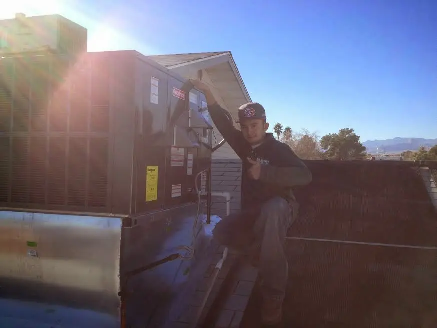 HVAC technician performing HVAC Inspection on a rooftop unit in Fort Morgan